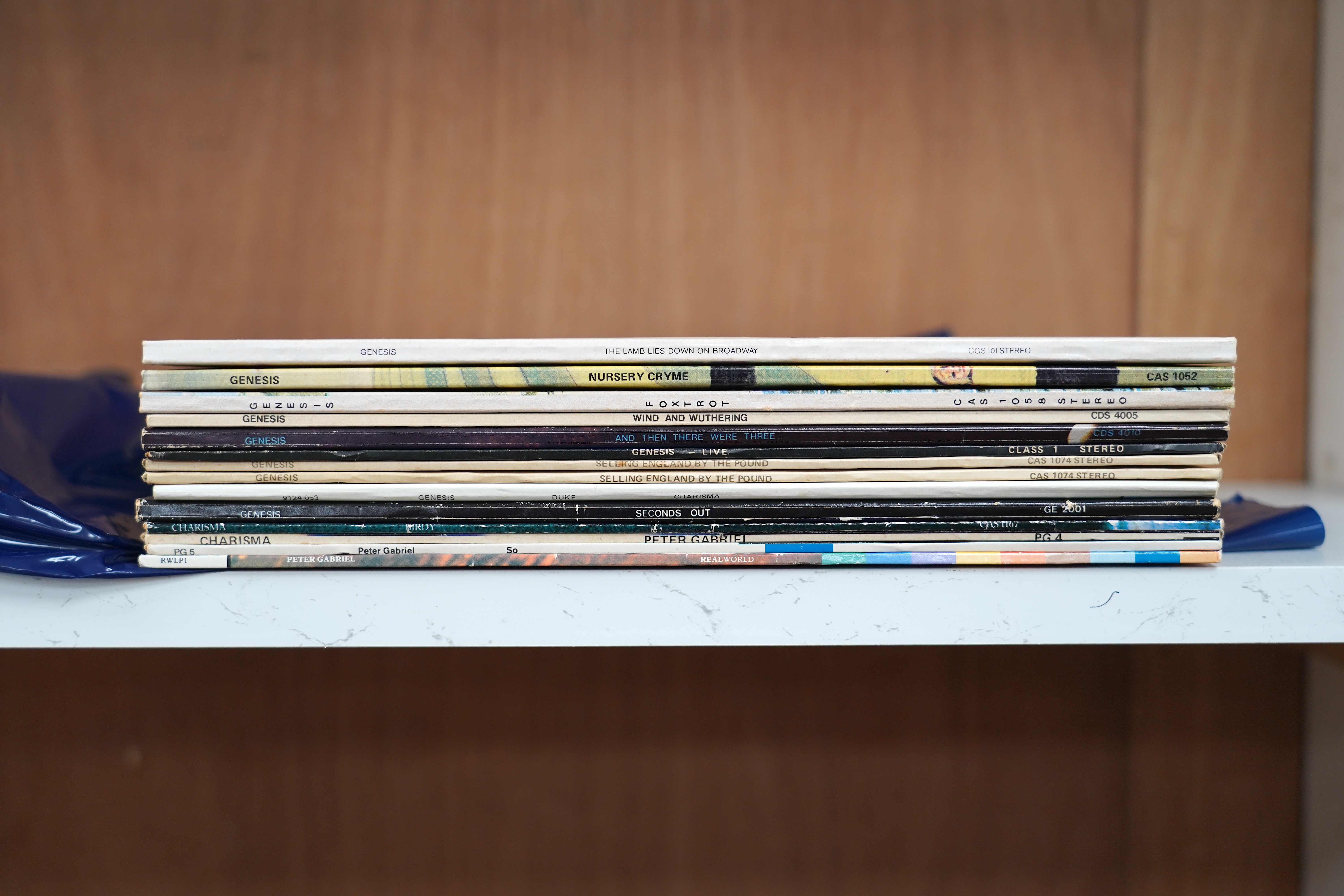 Fourteen Genesis and Peter Gabriel LP record albums, including; Nursery Cryme, Foxtrot, The Lamb Lies Down on Broadway, Wind & Wuthering, …and then there were three…, Genesis Live, Selling England by the Pound, Duke, Sec